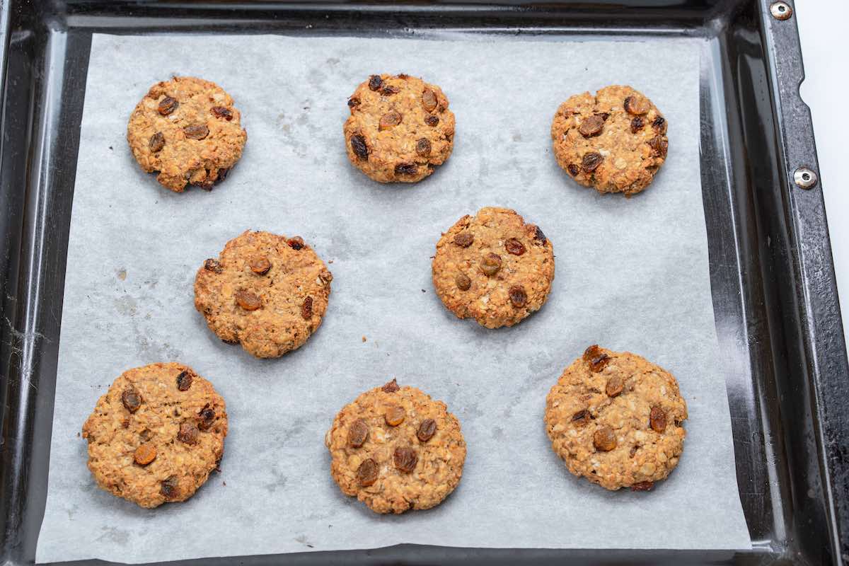 baked oatmeal raisin cookies on a baking sheet.
