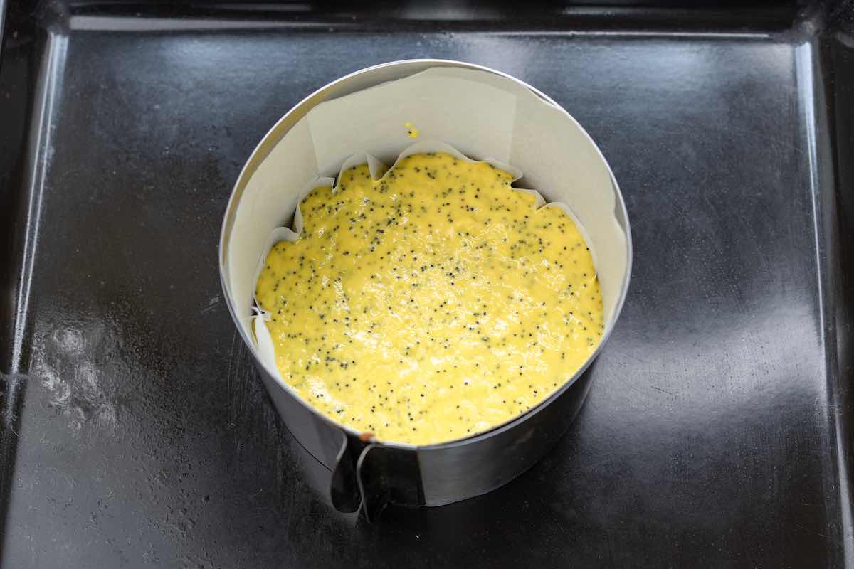 lemon poppy seed cake batter in a cake pan.