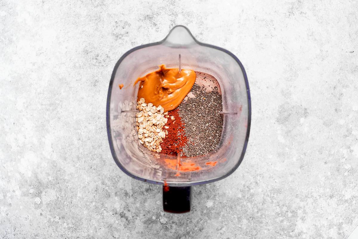 peanut butter, oats, cocoa powder, chia seeds, maple syrup, and milk in a blender.
