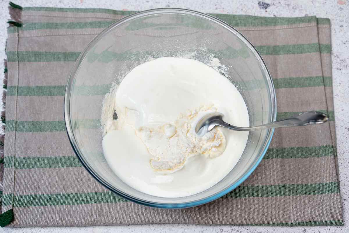 self rising flour and yogurt in a mixing bowl.