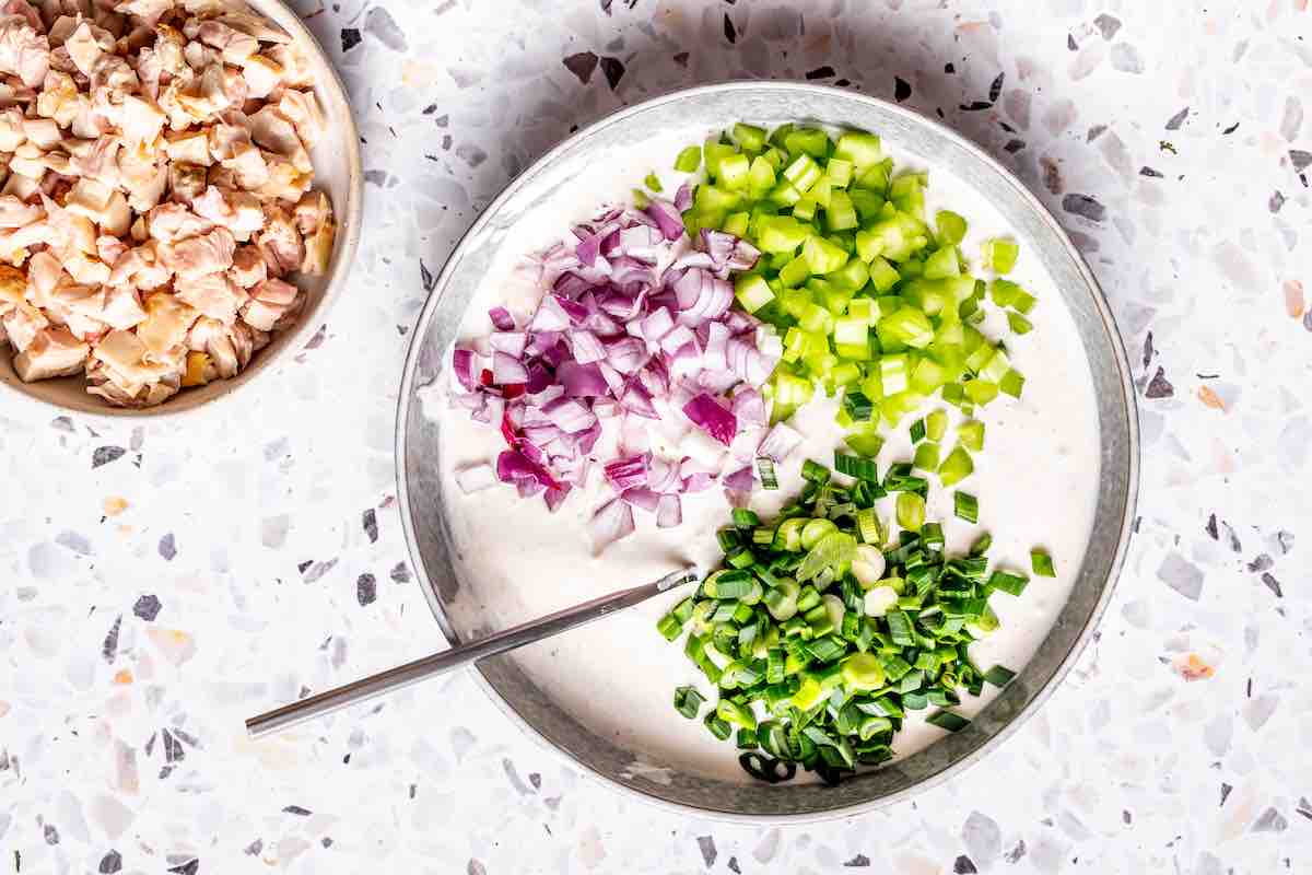 onions, celery, and green onions in dressing.