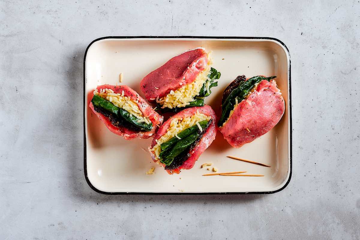 raw pork chops filled with spinach, cheese, and sun-dried tomatoes.
