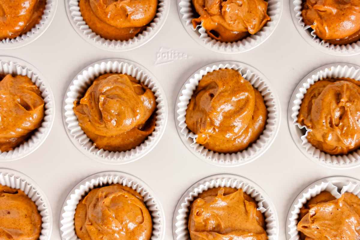 sweet potato muffin batter in muffin tin.