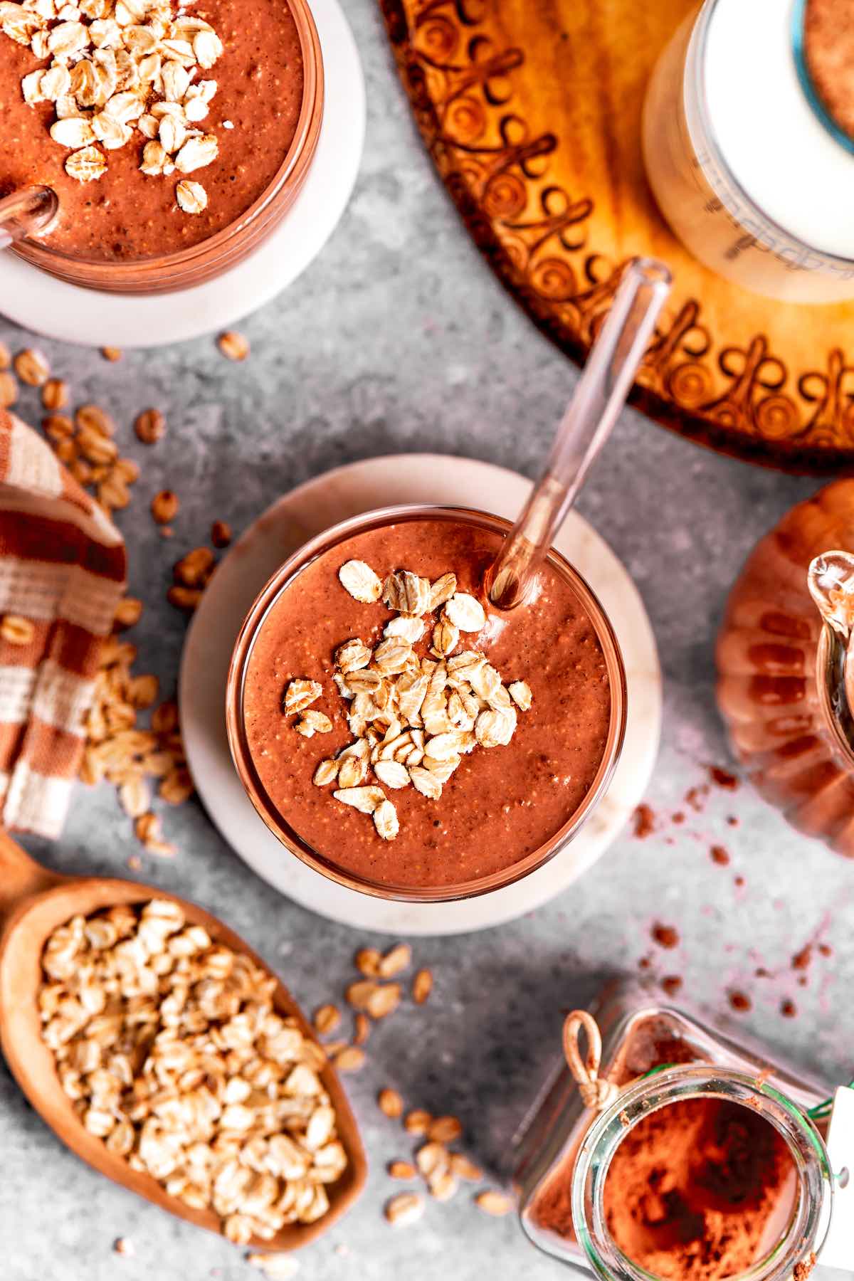 oatmeal smoothie in a glass with a straw.