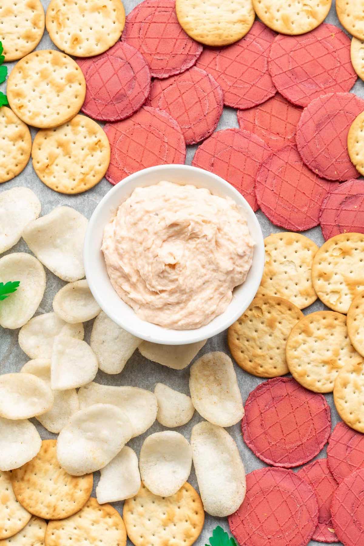 salmon dip with crackers on a platter.