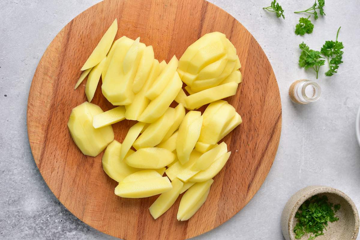 sliced raw fries on a chopping board.