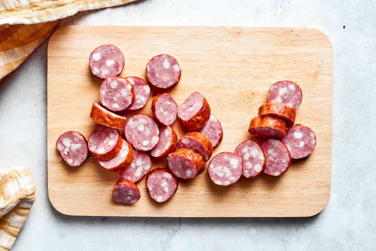 sliced kielbasa on a chopping board.