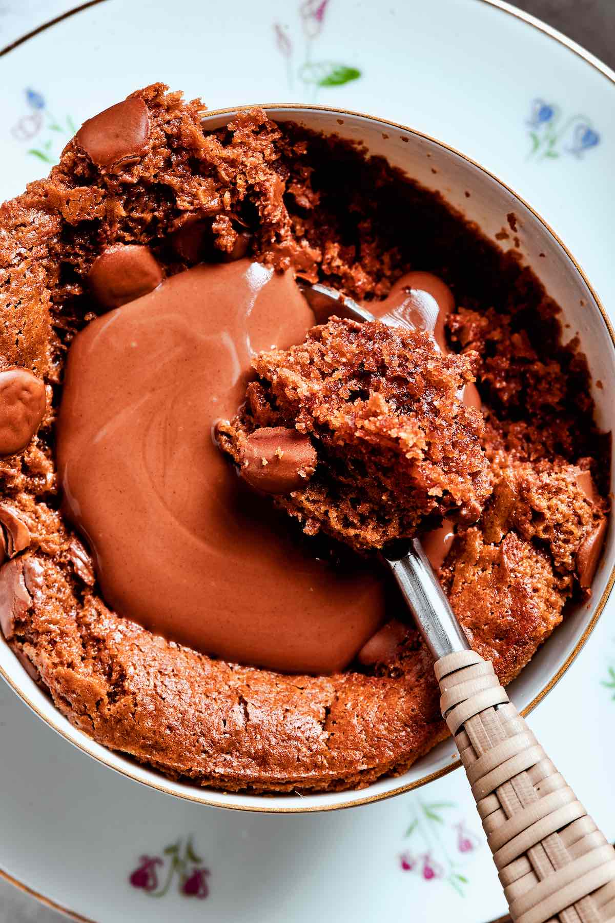 almond flour mug cake with a pool of melted chocolate on top.