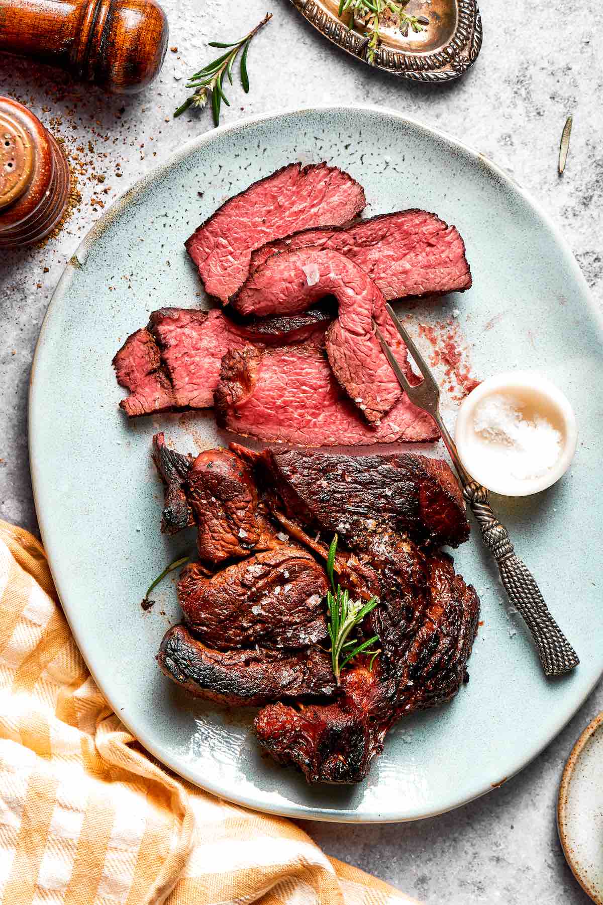 grilled chuck roast recipe, sliced, on a plate.