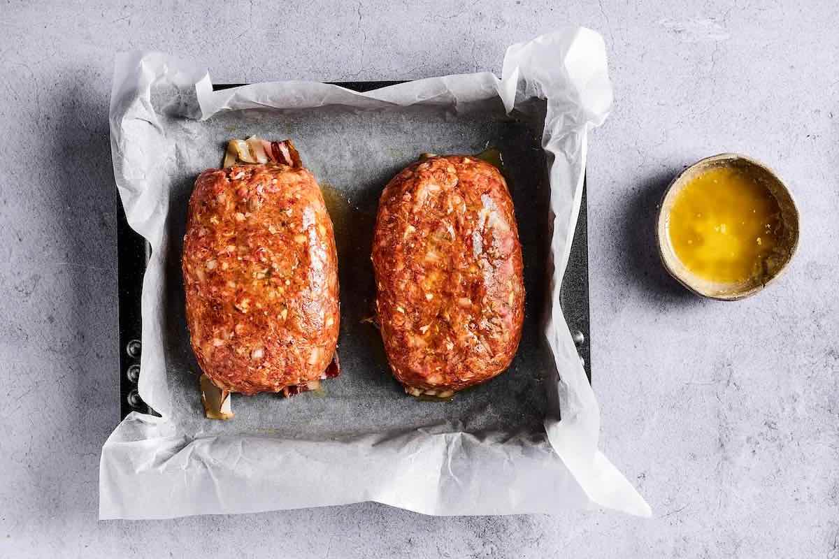 shaped loafs of gyro meat in a baking pan.