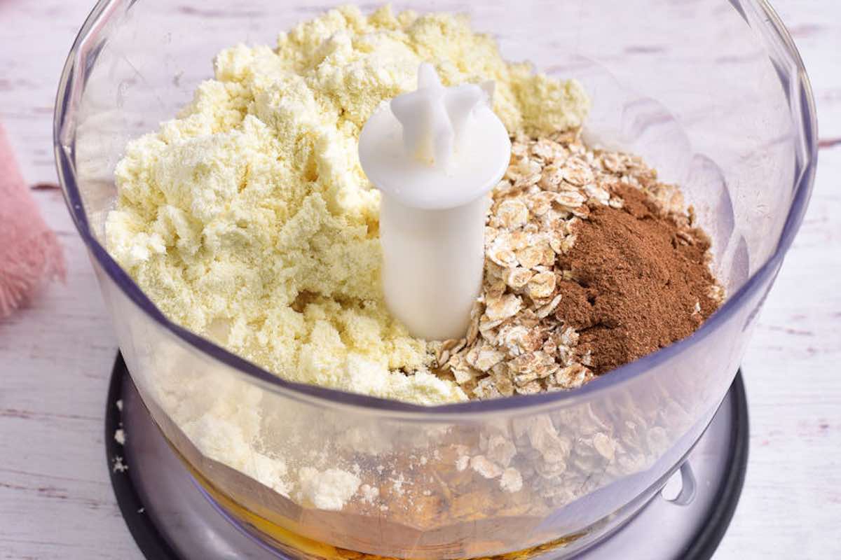 oats, protein powder, maple syrup, coconut oil, and spices in a food processor.