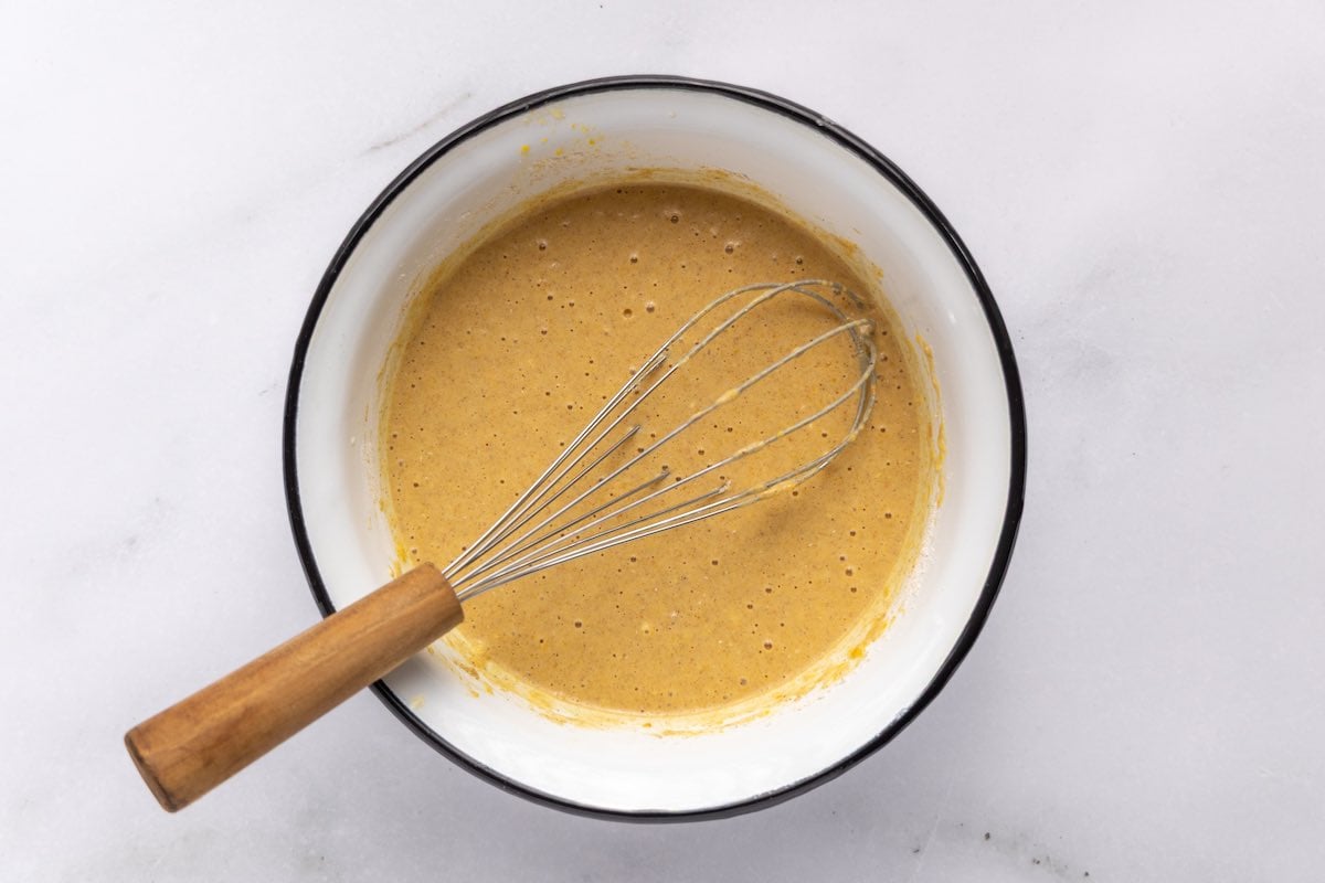 pumpkin pancake batter in a mixing bowl.