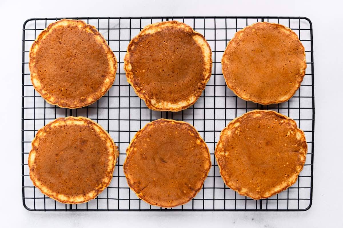 pumpkin pancakes on a wire rack.