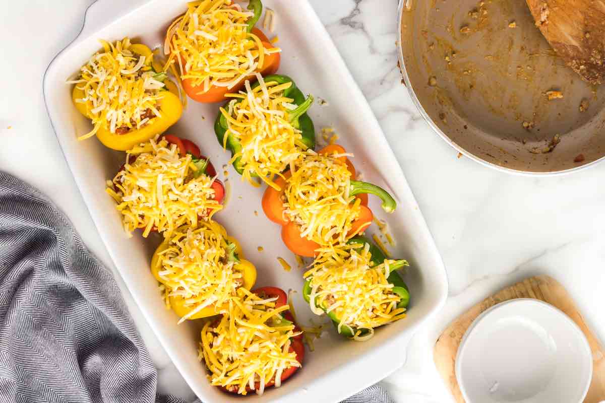 assembled stuffed peppers in a baking dish.
