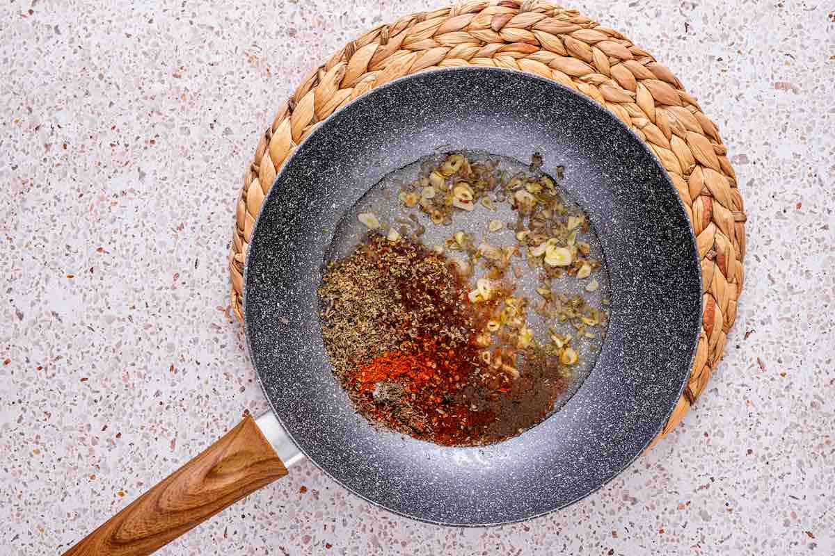 clam sauce warming up in a skillet.