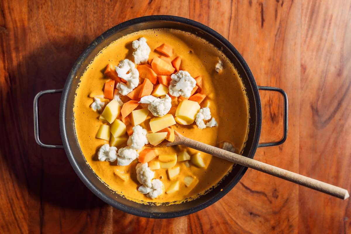 korma with chopped potatoes, carrots, and cauliflower.