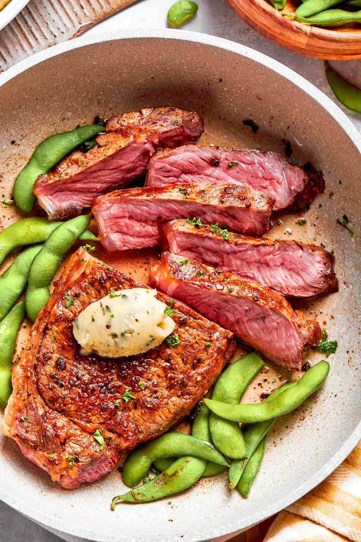 sliced shoulder steak with green beans and garlic butter.