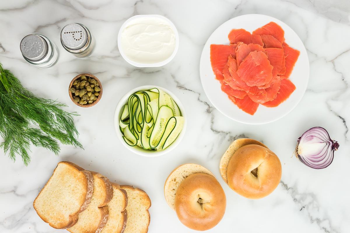 smoked salmon bagel ingredients- smoked salmon, onion, bagels, capers, dill, cucumber, and salt.