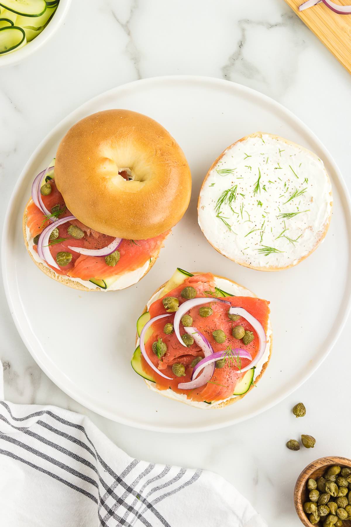 open faced smoked salmon bagel with capers, cream cheese, and red onion.