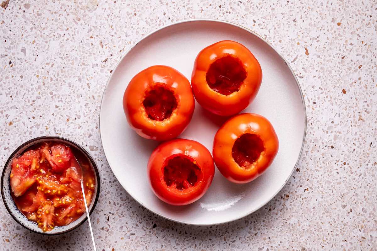 scooped out tomatoes on a plate.