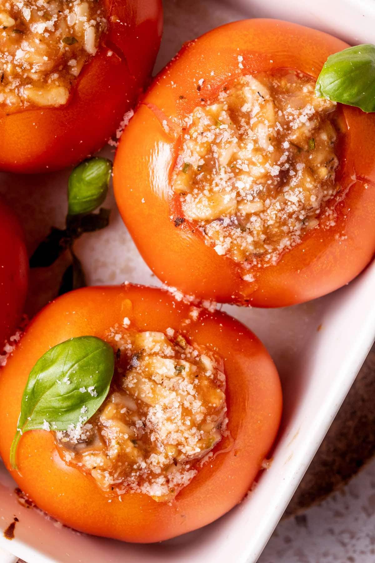 stuffed tomatoes with fresh basil leaves on top.
