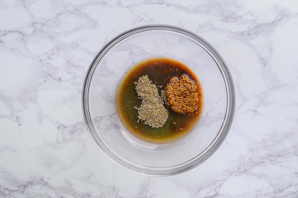 mustard, Rosemary, olive oil, and balsamic vinegar in a bowl.