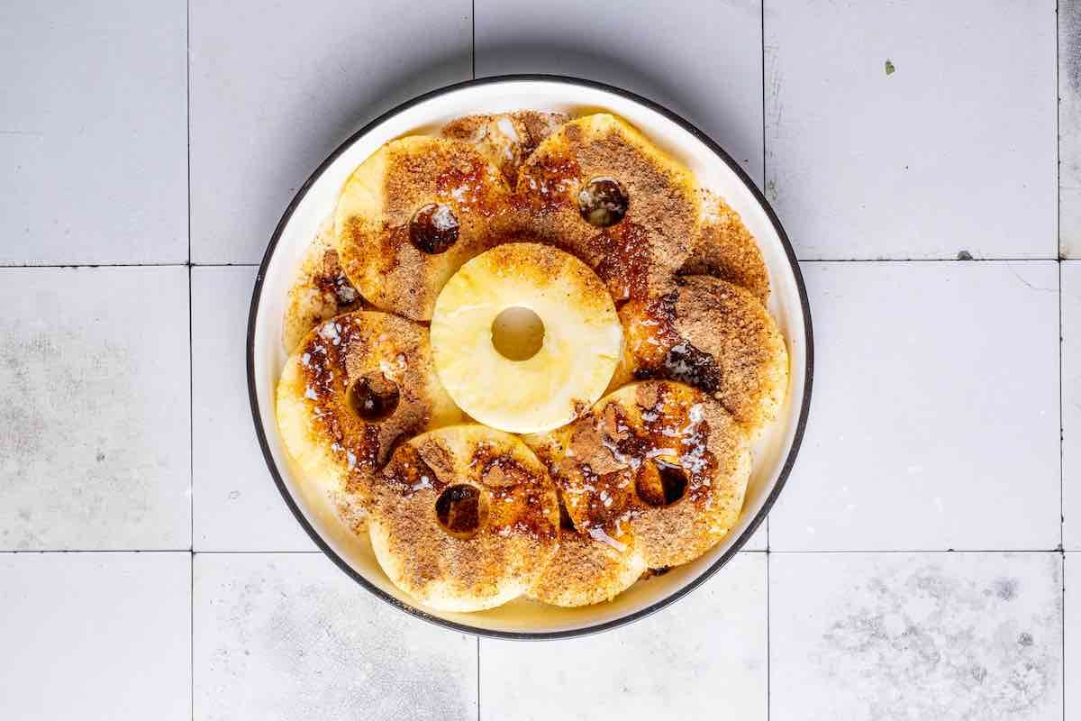 seasoning pineapple with butter, brown sugar, and spices.