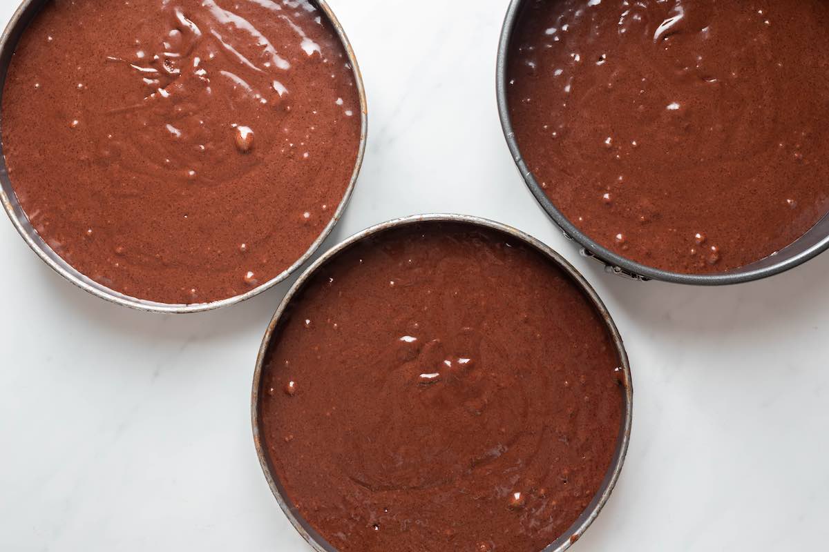cake batter in three cake pans.