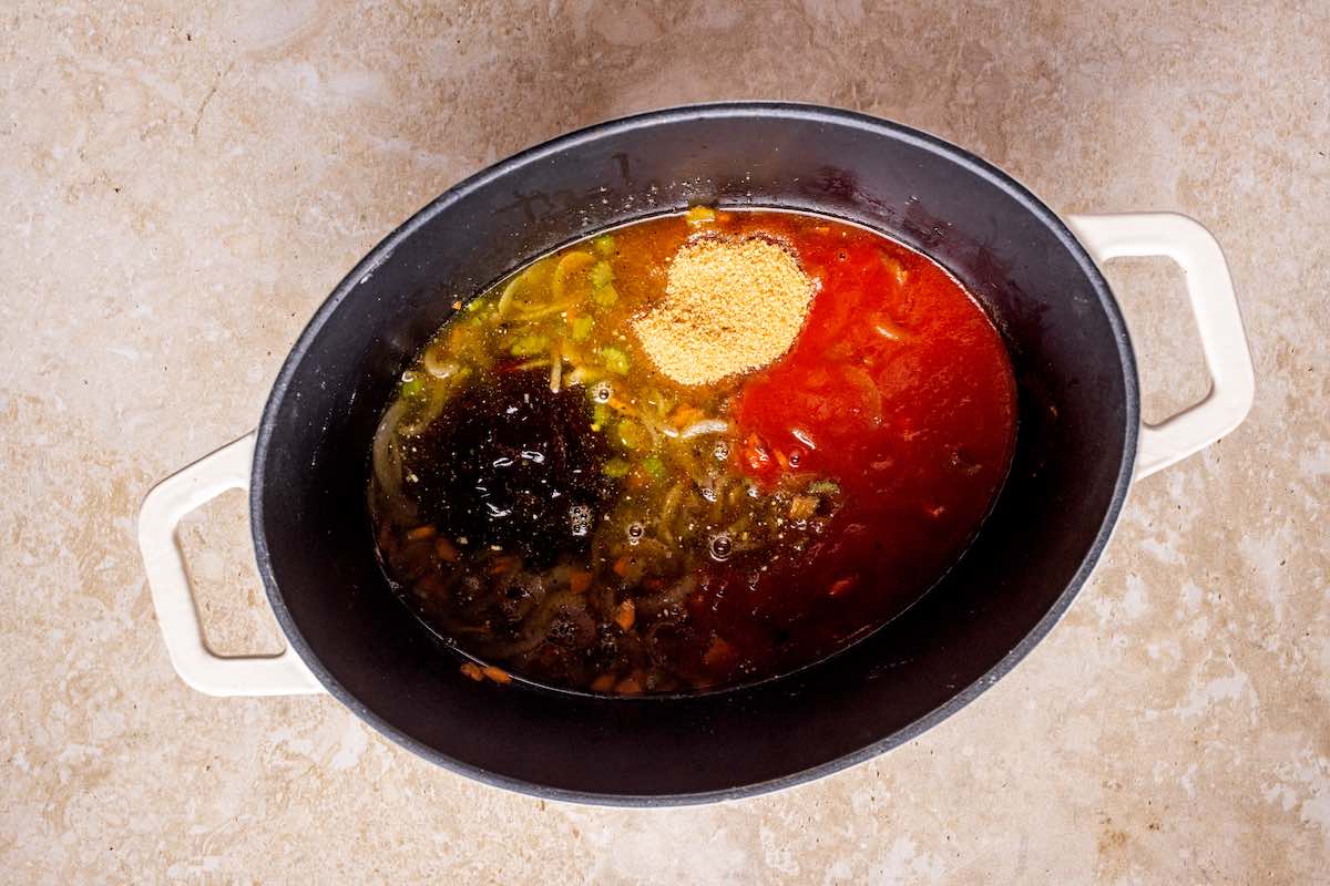broth, tomato, and seasonings in pot.