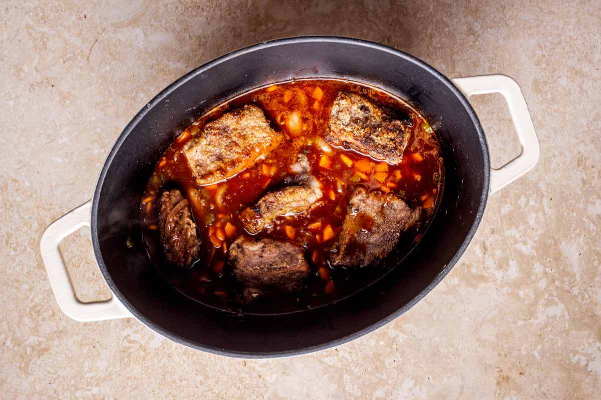 short ribs and broth simmering in pot.