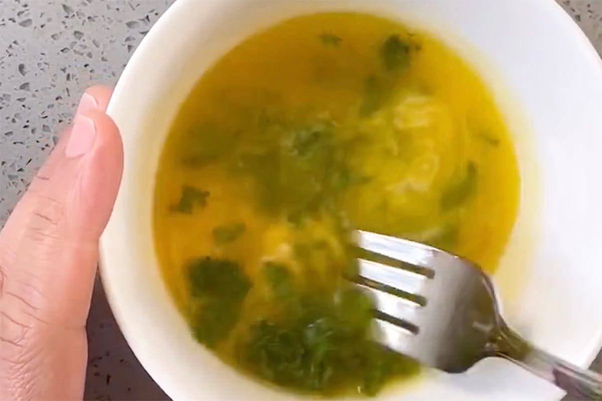 melted butter, garlic, and herbs in a bowl.