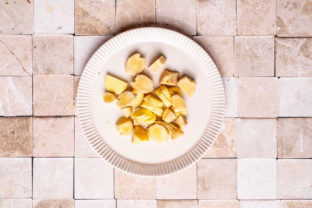 chopped and peeled ginger on a plate.