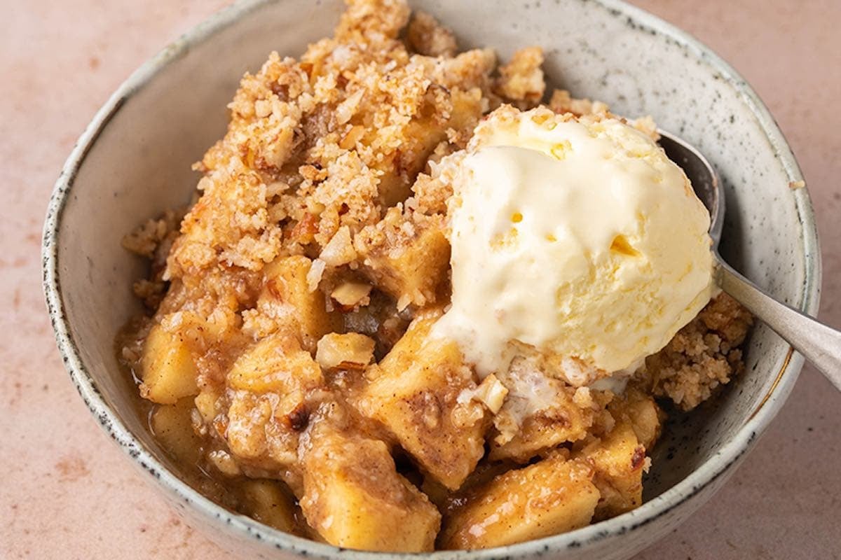 healthy apple crisp with ice cream on top.