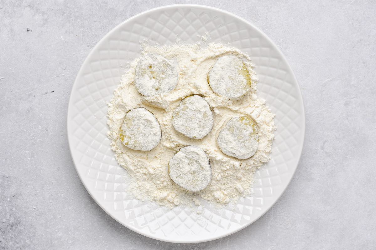 coating pickle slices in flour.