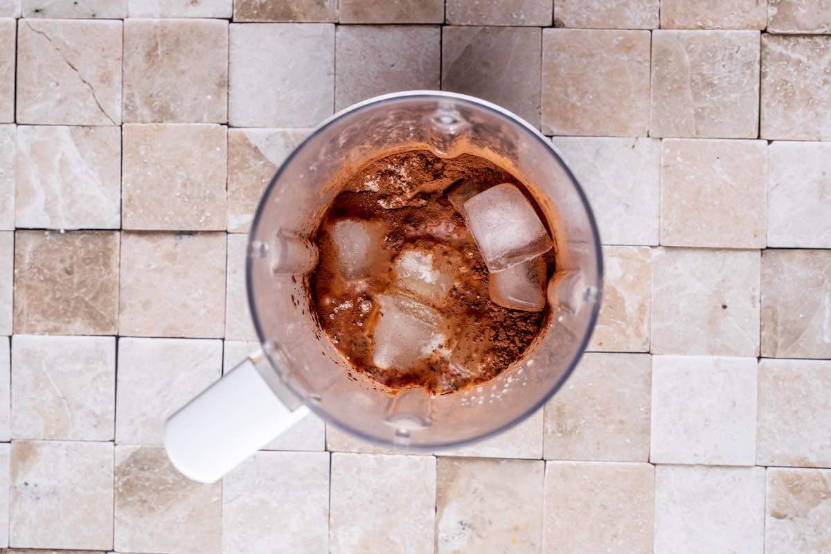 ice, protein, cocoa powder, frozen banana, and milk in blender.