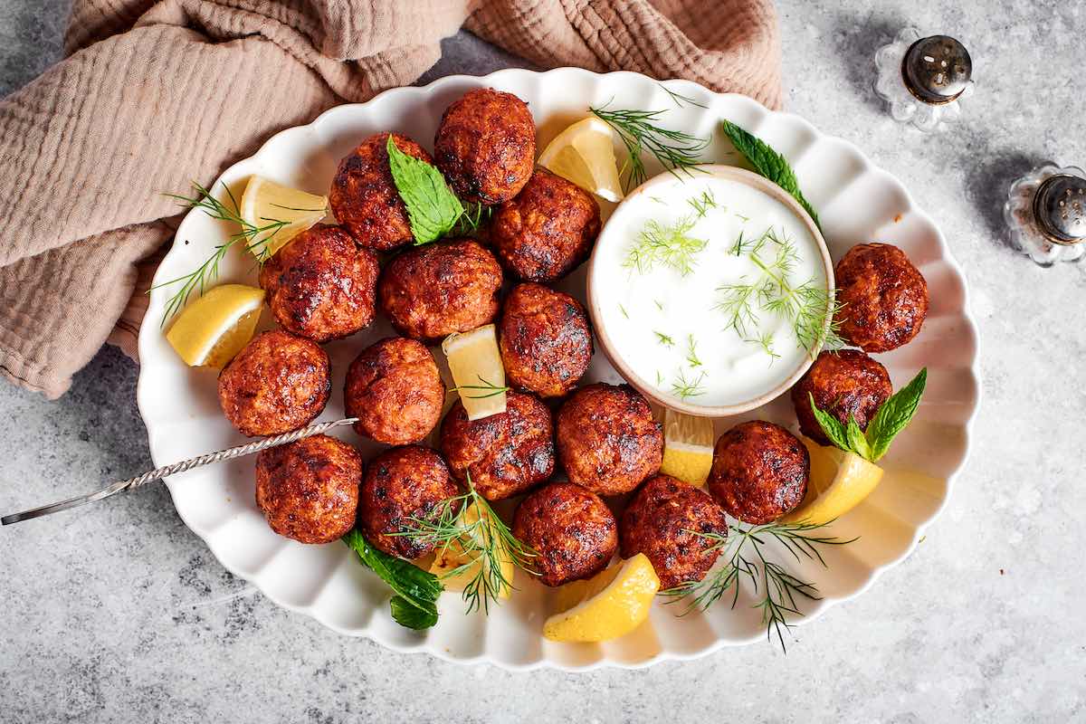 plate of air fried frozen meatballs with dipping sauce.