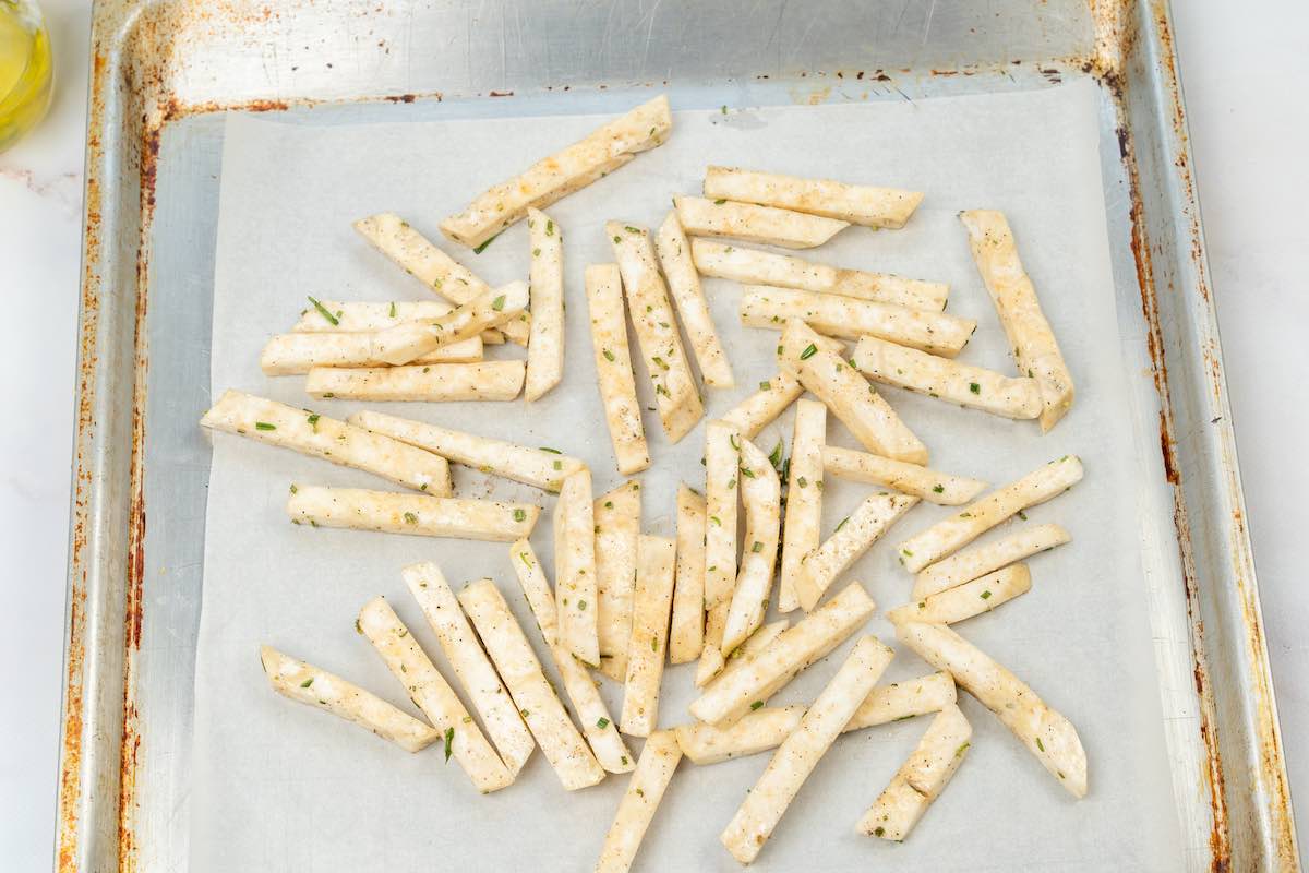 seasoned fries on a baking sheet.