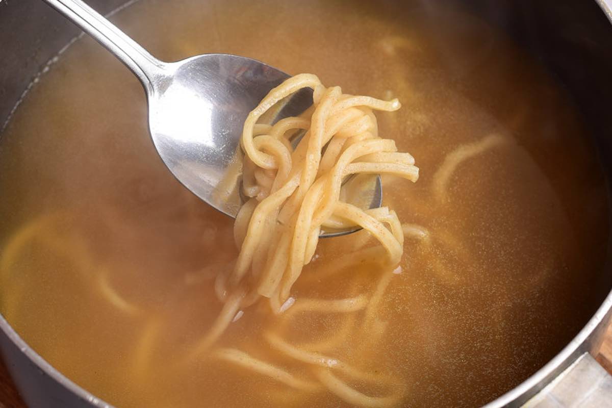 adding noodles to the broth.