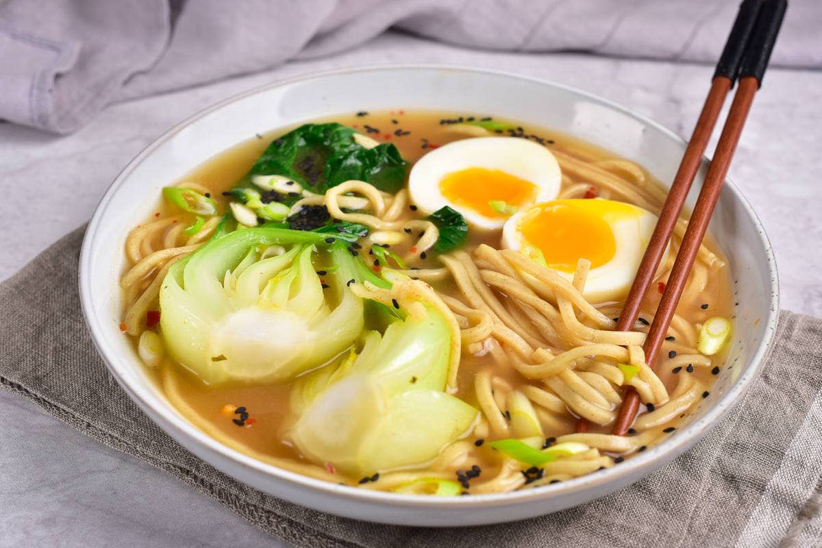 assembled keto ramen with boy choy and a soft boiled egg on top.
