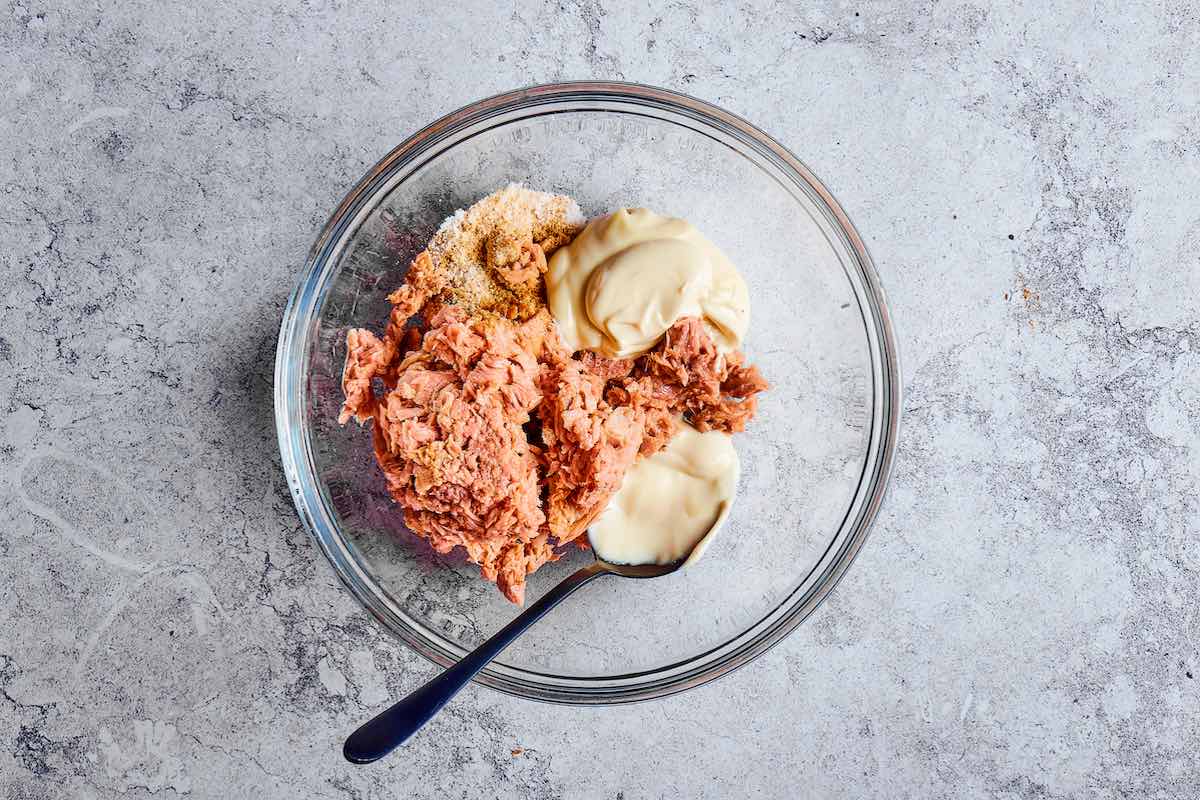 tuna, mayonnaise, eggs, and spices in a bowl.