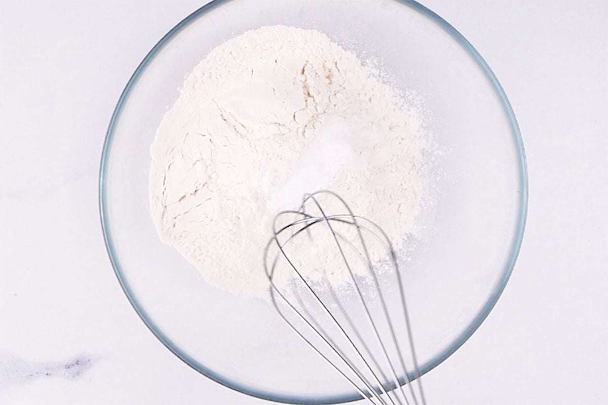 flour, baking powder, and baking soda in a bowl.