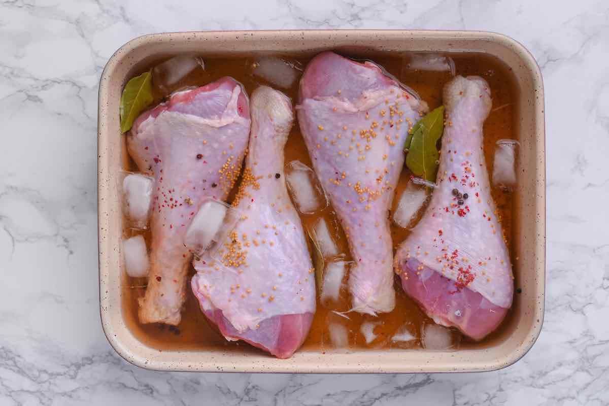 raw turkey legs soaking on brining liquid.