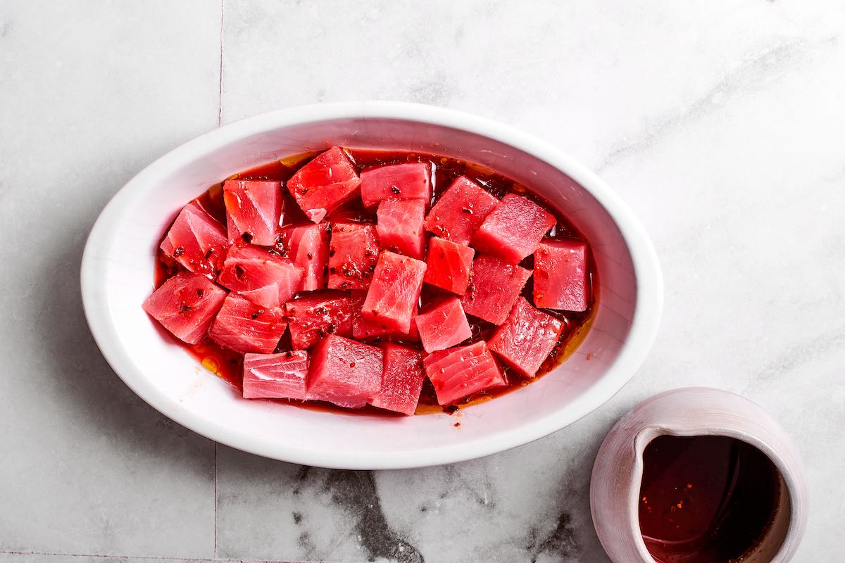 raw tuna chunks in soy sauce, sesame oil, and sesame seeds.