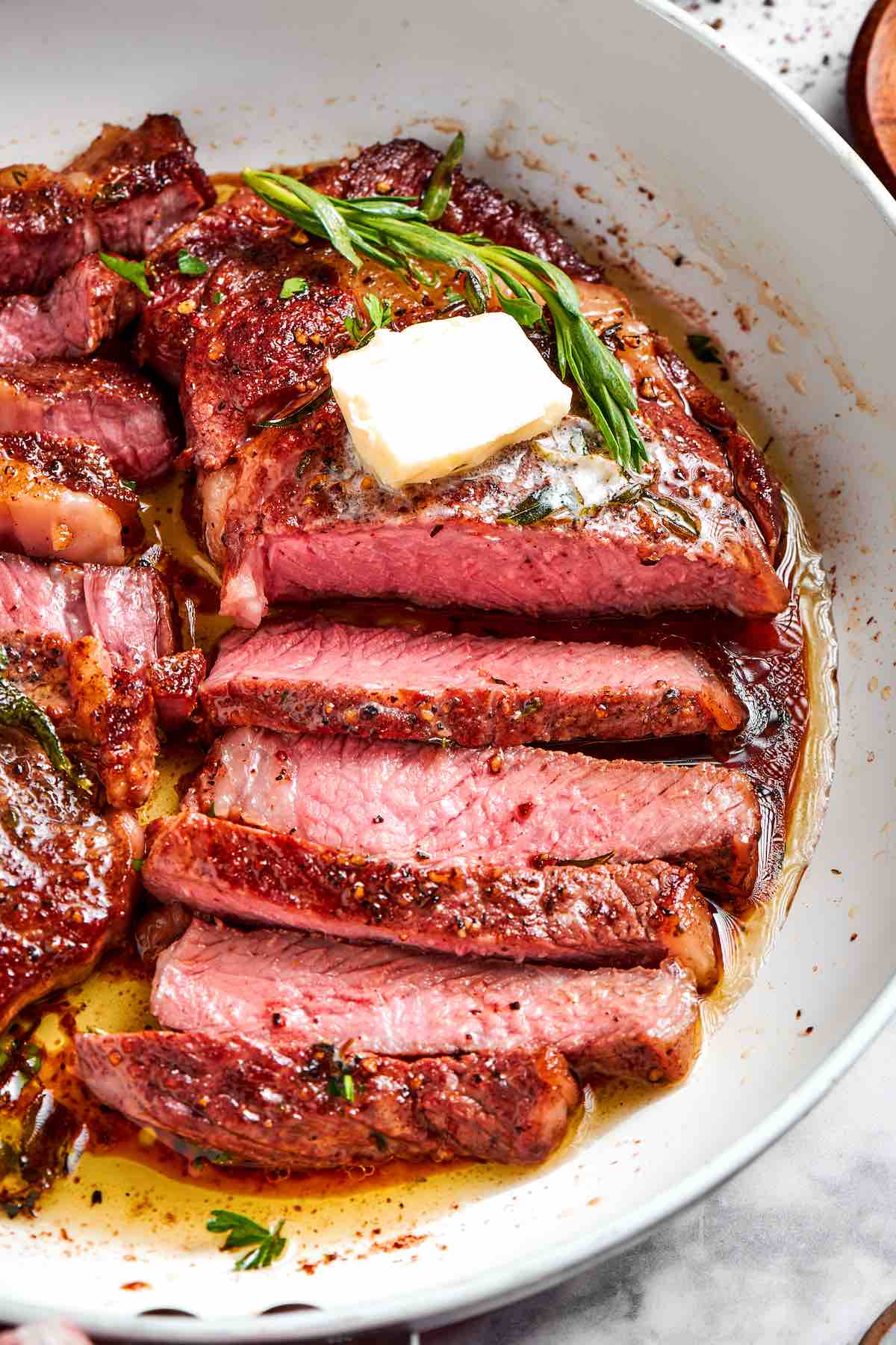 sliced Delmonico steak with pat of butter.