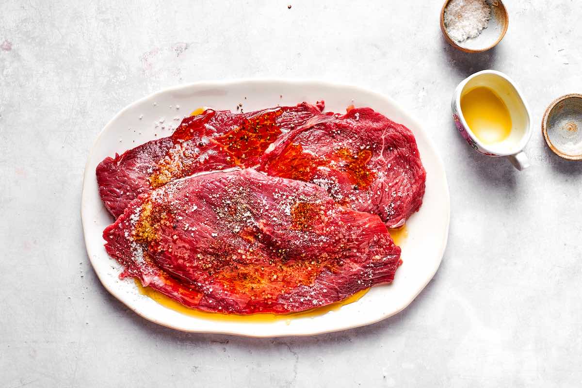 raw minute steaks with salt, pepper, and olive oil.