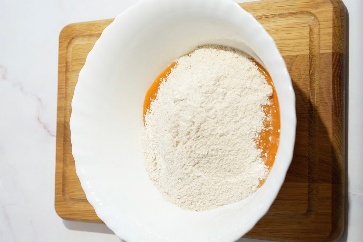 cake mix and pumpkin puree in a bowl.