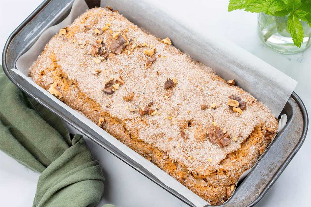 baked bread with sugar cinnamon topping and pecans on top.