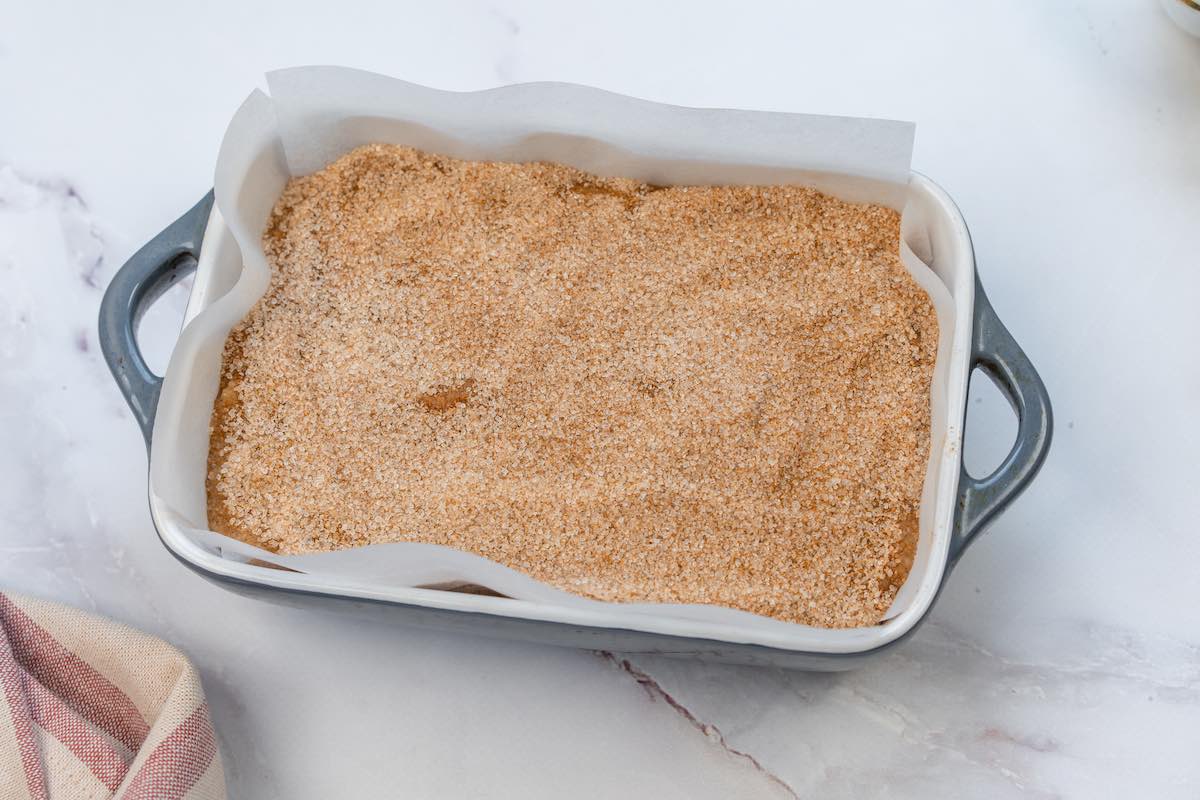 assembled banana bread batter in baking dish with cinnamon sugar on top.