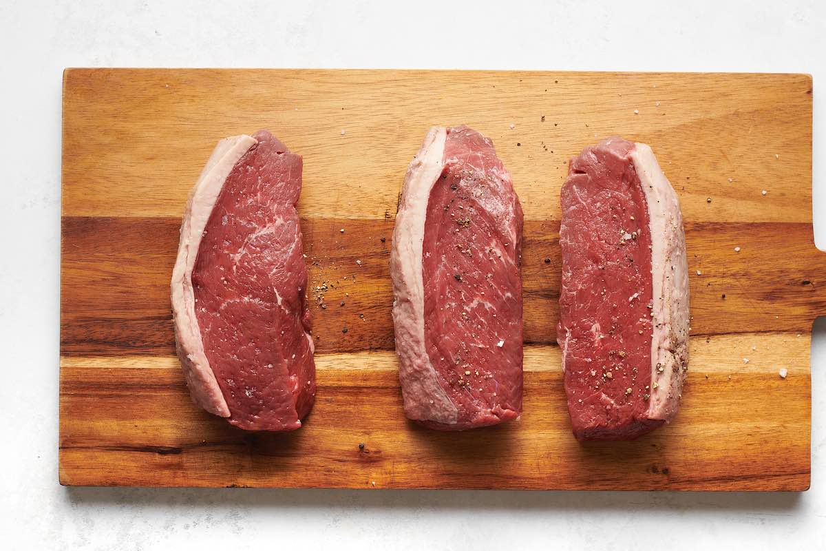seasoned raw coulotte steaks.