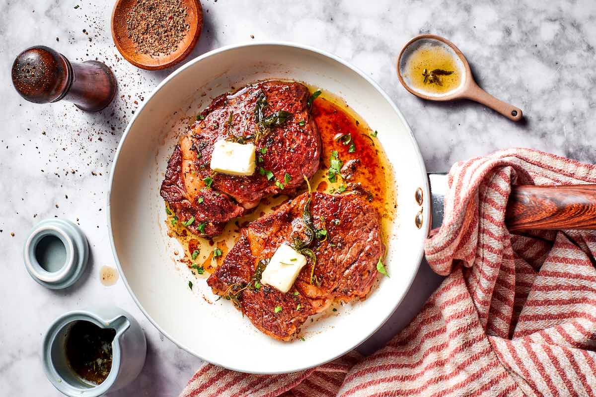 cooked Delmonico steaks with butter on top.